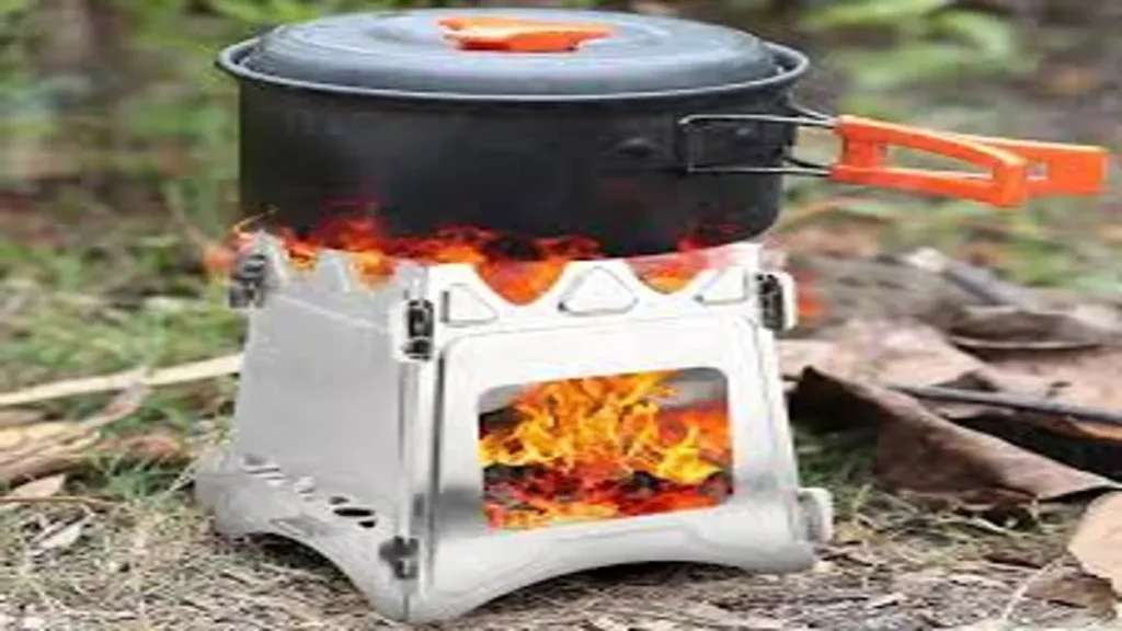 Portable wood-burning camp stove boiling water outdoors, demonstrating lightweight cooking equipment for UK preppers.
