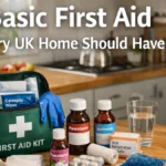 First aid kit and basic supplies laid out on a wooden kitchen worktop in a calm UK home, with the headline “Basic First Aid kit UK Home Should Have”.